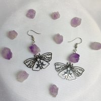 Silver butterfly drop earrings with raw amethyst clusters.