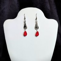 Gothic vampire bat earrings with red or black bead drops.