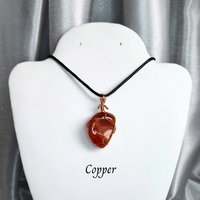 Carnelian tumblestone wrapped in gold, rose gold or copper wire.
