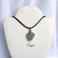 Raw celestite wrapped in gold, rose gold or copper wire with cord.