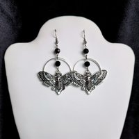 Silver death mask earrings with metal ring and black crystal beads.
