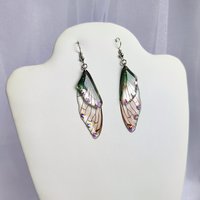 Fairy dangle earrings with clear and green resin fairy wings, glitter and diamantes. 