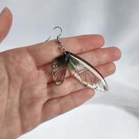 Fairy dangle earrings with clear and green resin fairy wings, glitter and diamantes. 