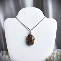 Unakite pendant wrapped in silver plated wire.