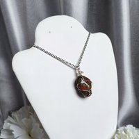 Unakite pendant wrapped in silver plated wire.