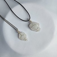 Clear quartz pendant wrapped in silver plated wire with chain or cord.