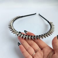 Studded headband with silver spikes wire wrapped onto a black headband.