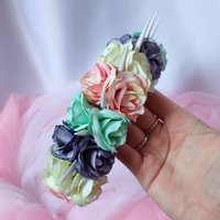 Bella unicorn headband with white spikes and pastel flowers in pink, green, purple and white.