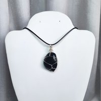 Obsidian wire wrapped pendant in silver with chain or cord.