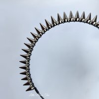 Studded headband with silver spikes wire wrapped onto a black headband.