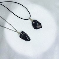 Obsidian wire wrapped pendant in silver with chain or cord.