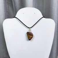 Tiger's eye wire wrapped pendant with chain or cord.