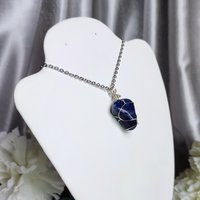 Sodalite wire wrapped pendant in silver.