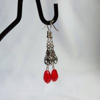 Gothic vampire bat earrings with red or black bead drops.
