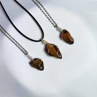 Tiger's eye wire wrapped pendant with chain or cord.