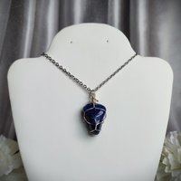 Sodalite wire wrapped pendant in silver.