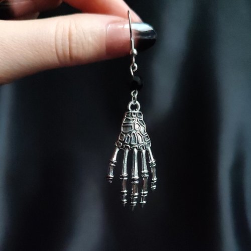 Pair of silver skeleton hand earrings.
