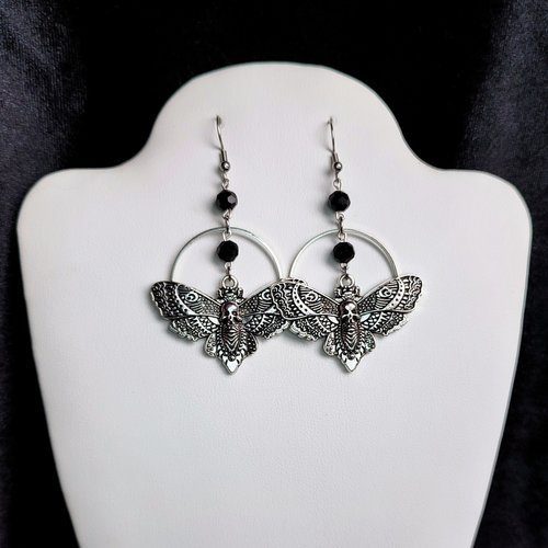 Silver death mask earrings with metal ring and black crystal beads.