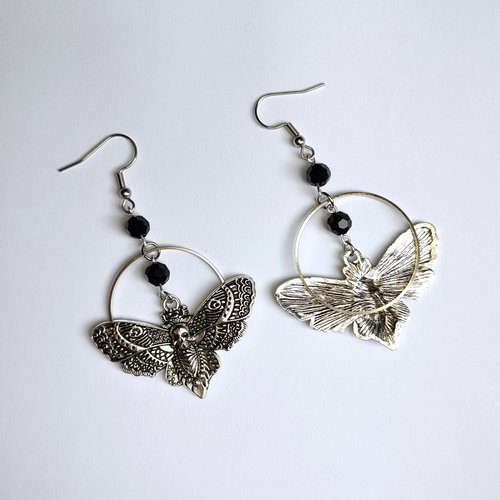 Silver death mask earrings with metal ring and black crystal beads.