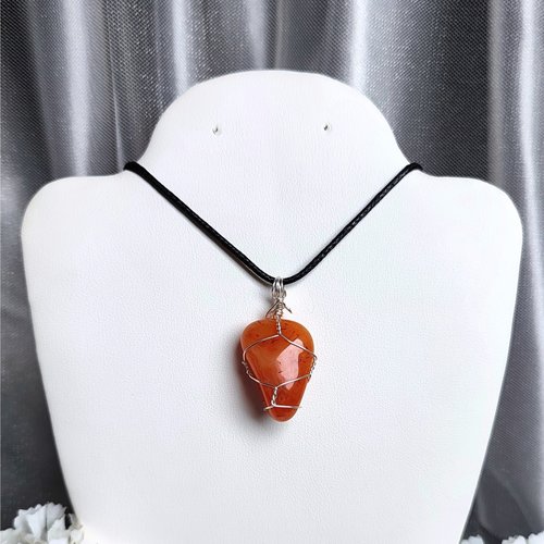 Carnelian pendant wrapped in silver plated wire with chain or cord.