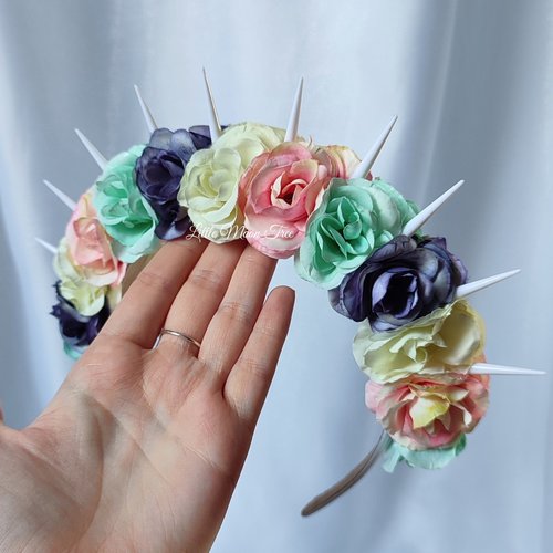Bella unicorn headband with white spikes and pastel flowers in pink, green, purple and white.