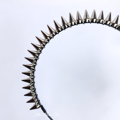 Studded headband with silver spikes wire wrapped onto a black headband.