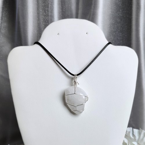 Clear quartz pendant wrapped in silver plated wire with chain or cord.