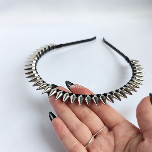 Studded headband with silver spikes wire wrapped onto a black headband.