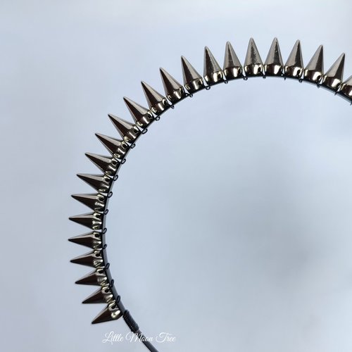 Studded headband with silver spikes wire wrapped onto a black headband.