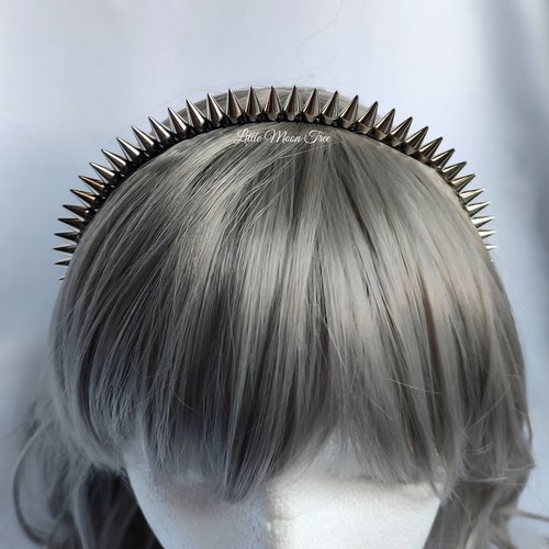 Studded headband with silver spikes wire wrapped onto a black headband.