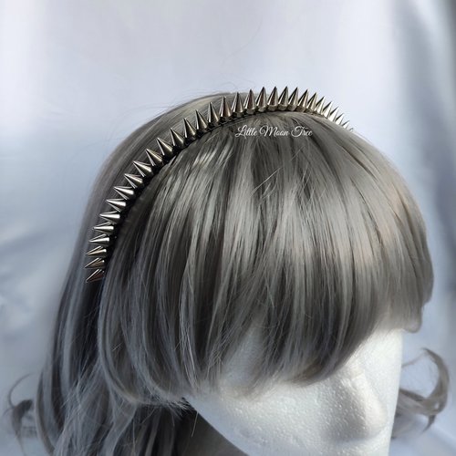 Studded headband with silver spikes wire wrapped onto a black headband.