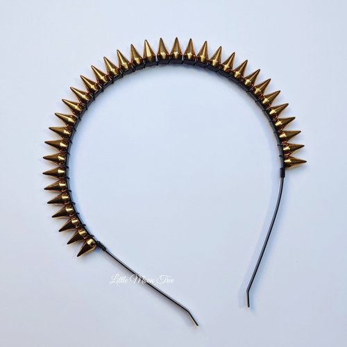 Studded headband with silver spikes wire wrapped onto a black headband.