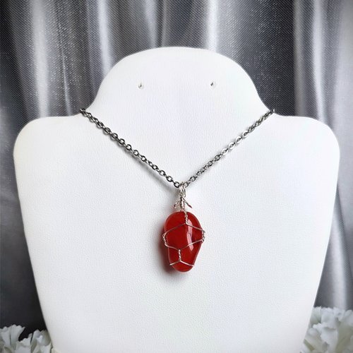 Carnelian pendant wrapped in silver plated wire with chain or cord.