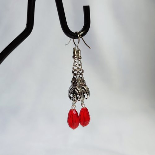 Gothic vampire bat earrings with red or black bead drops.
