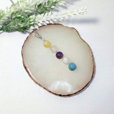 Depression pendant with citrine, rose quartz, amethyst, moonstone, aquamarine and chain or cord.