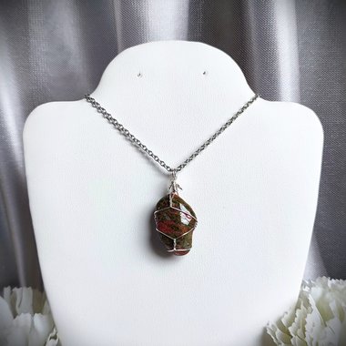 Unakite pendant wrapped in silver plated wire.
