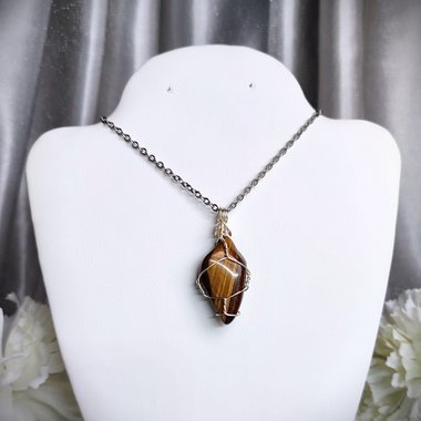 Tiger's eye wire wrapped pendant with chain or cord.