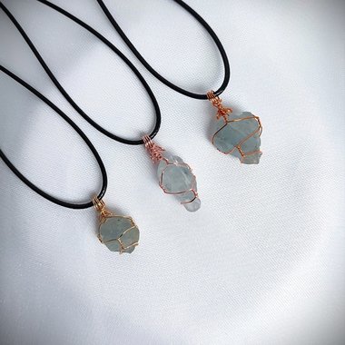 Raw celestite wrapped in gold, rose gold or copper wire with cord.