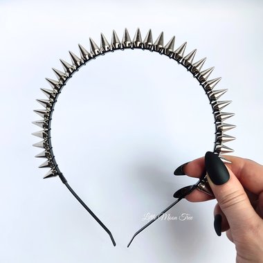Studded headband with silver spikes wire wrapped onto a black headband.
